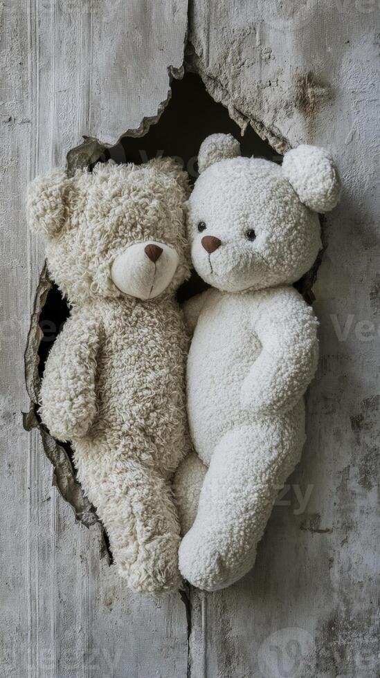 Two teddy bears cuddling through a torn wall in a cozy setting photo