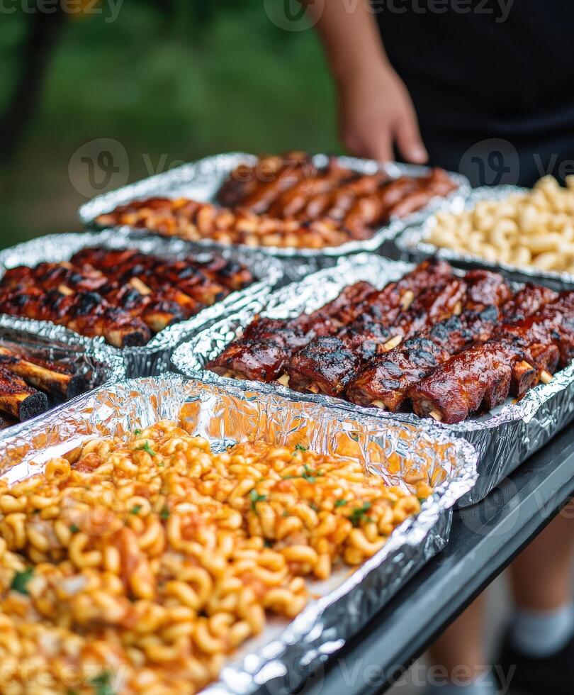 Rich barbecue feast with grilled meats and pasta salad served outdoors photo