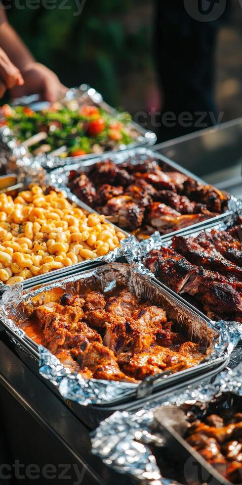 Delicious barbecue spread with various side dishes at outdoor gathering photo