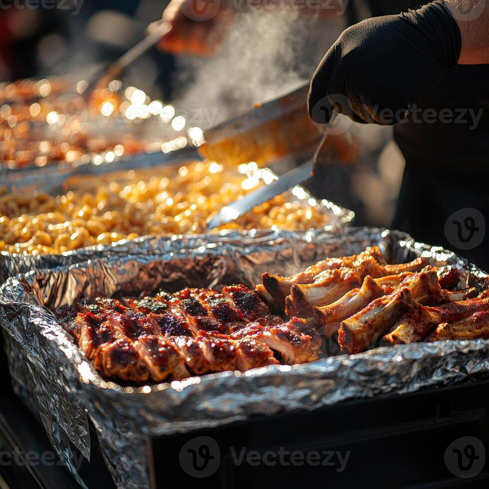 Grilling barbecue ribs and pasta at a summer outdoor gathering photo