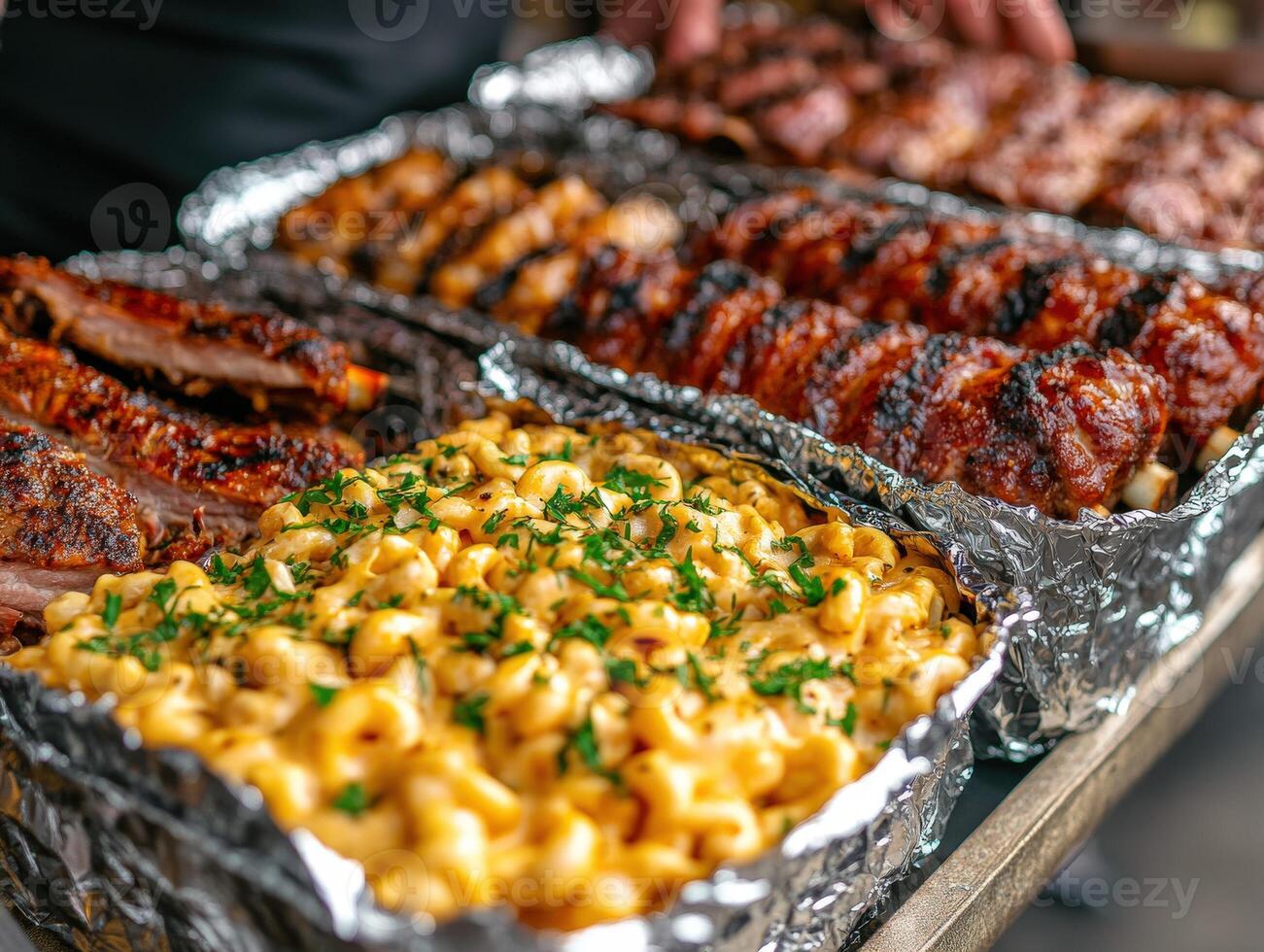 Delicious barbecue spread with ribs and macaroni at outdoor gathering photo