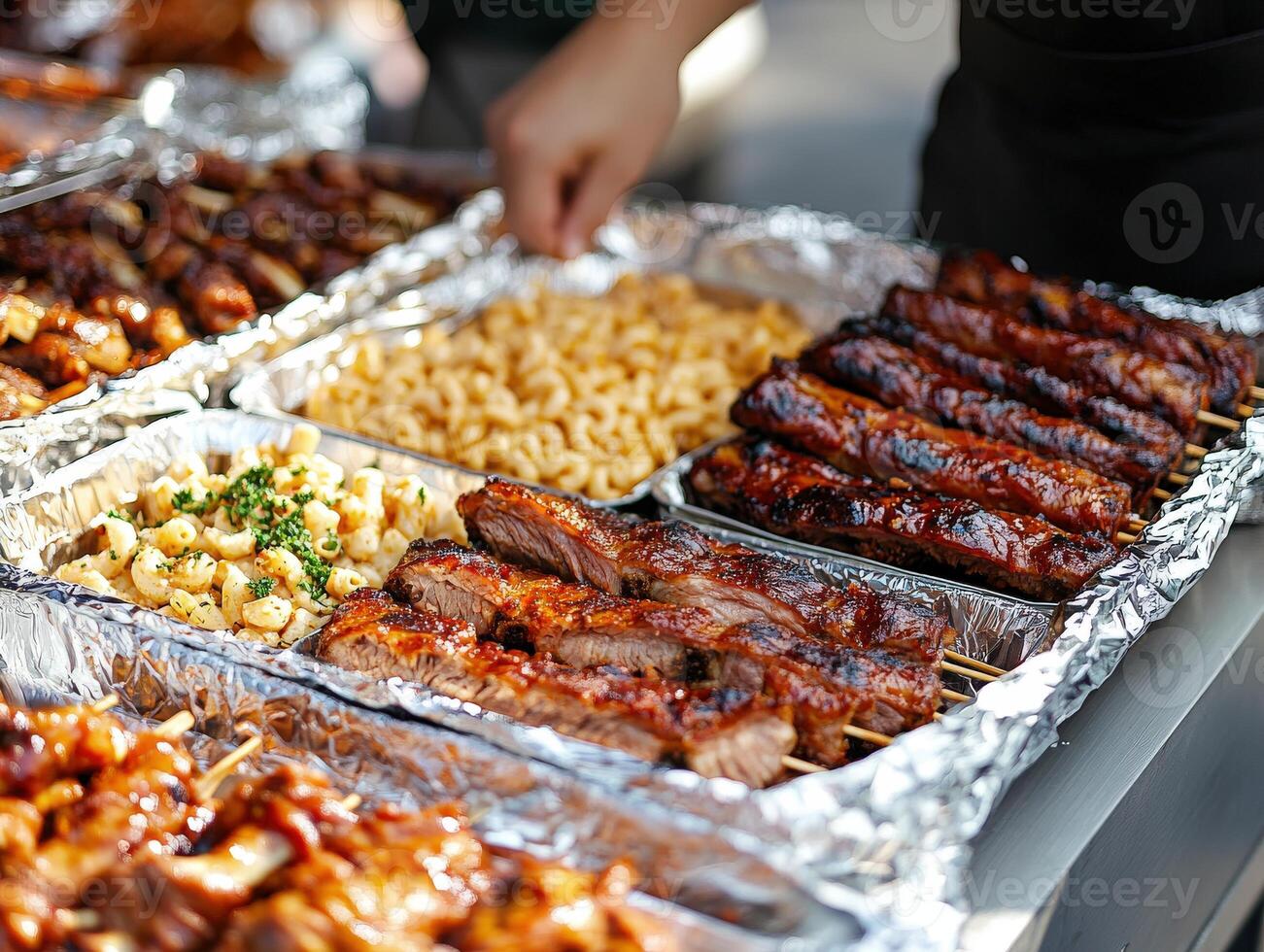 Grilled meats and sides displayed at outdoor food event in a summer setting photo