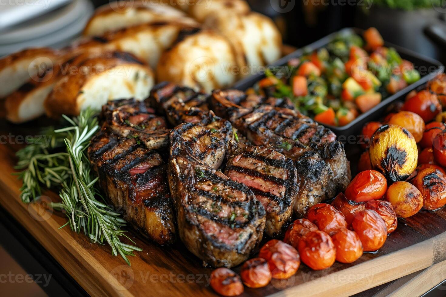 Grilled lamb chops with roasted vegetables and bread on cutting board photo