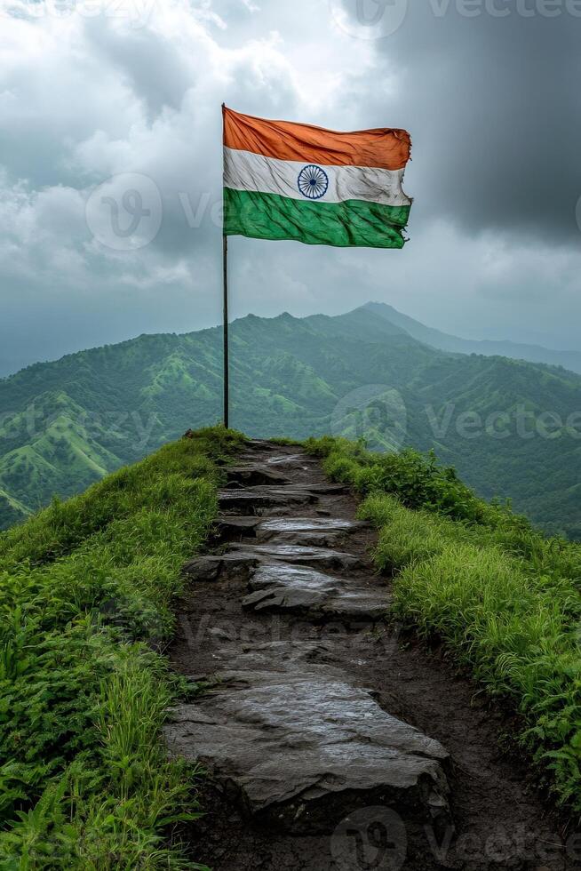 Indian flag waving on mountain top under cloudy sky photo