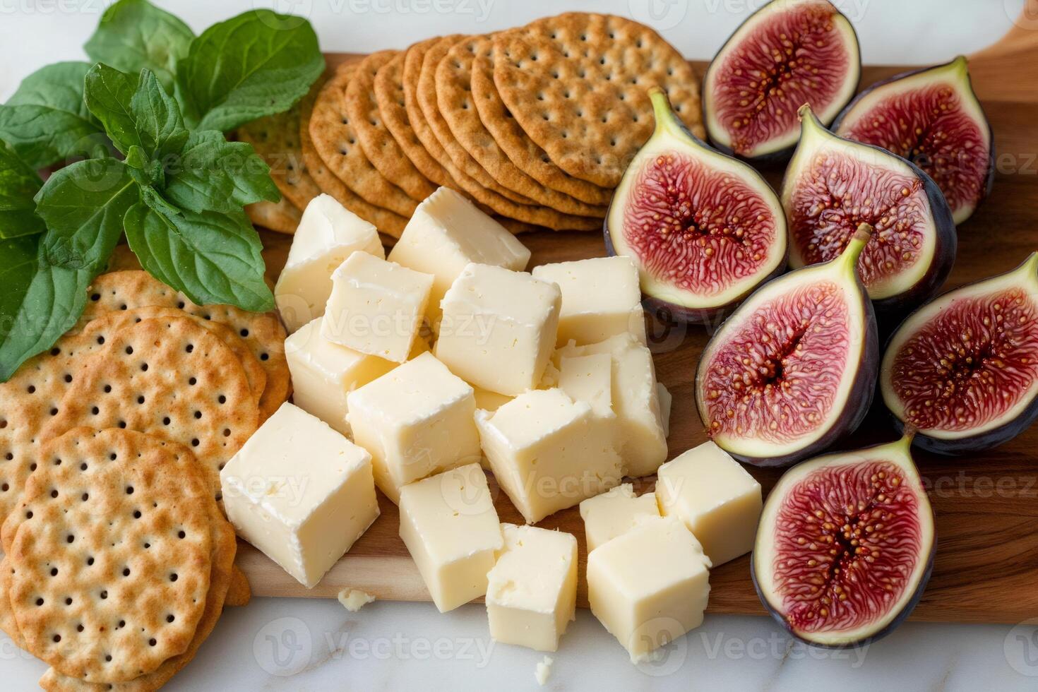 Cheese, figs and crackers creating delicious snack combination on wooden board photo