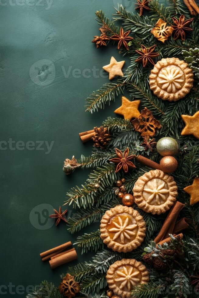 Christmas baking background featuring mince pies, star-shaped cookies, and pine branches with copy space photo