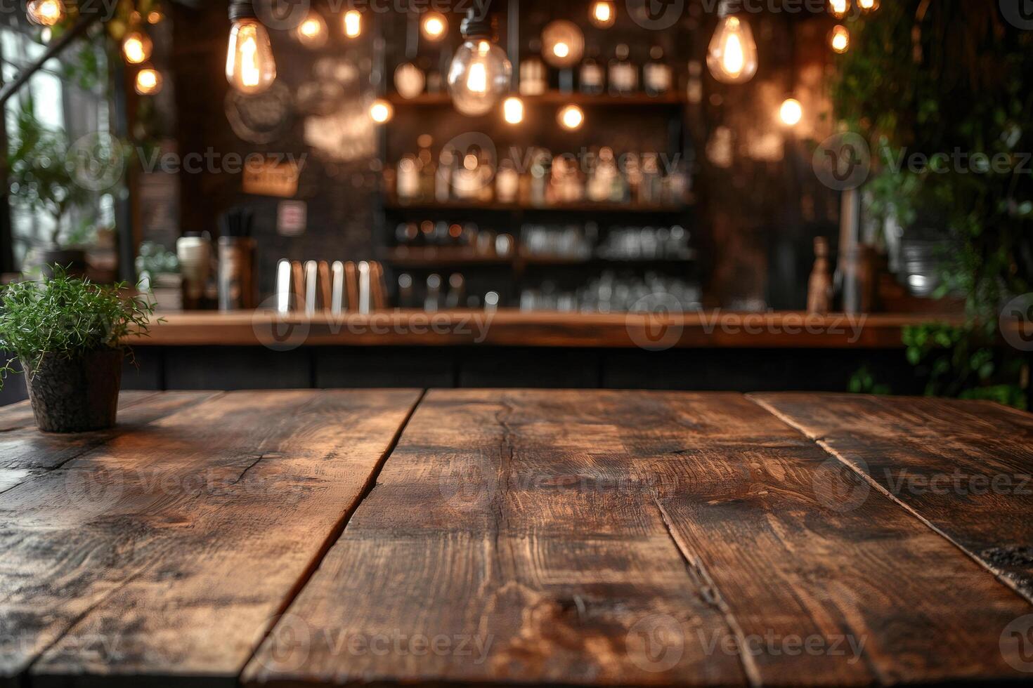 Empty wooden table in front of blurred cafe background with edison bulbs lighting photo