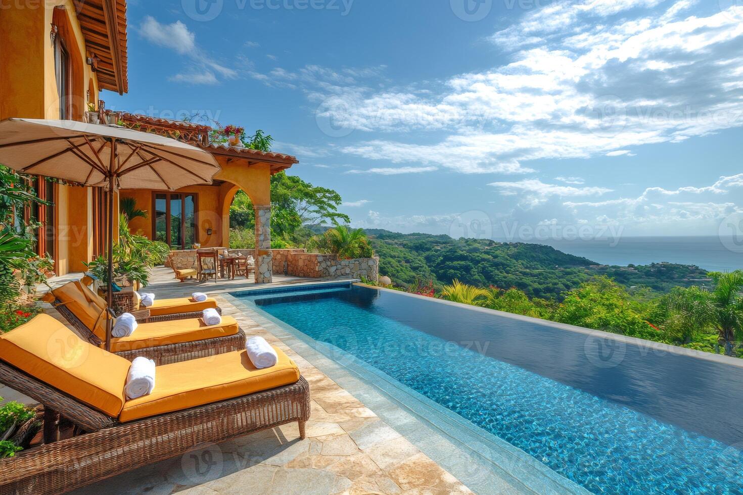 Infinity pool overlooking tropical rainforest and ocean at luxury resort photo