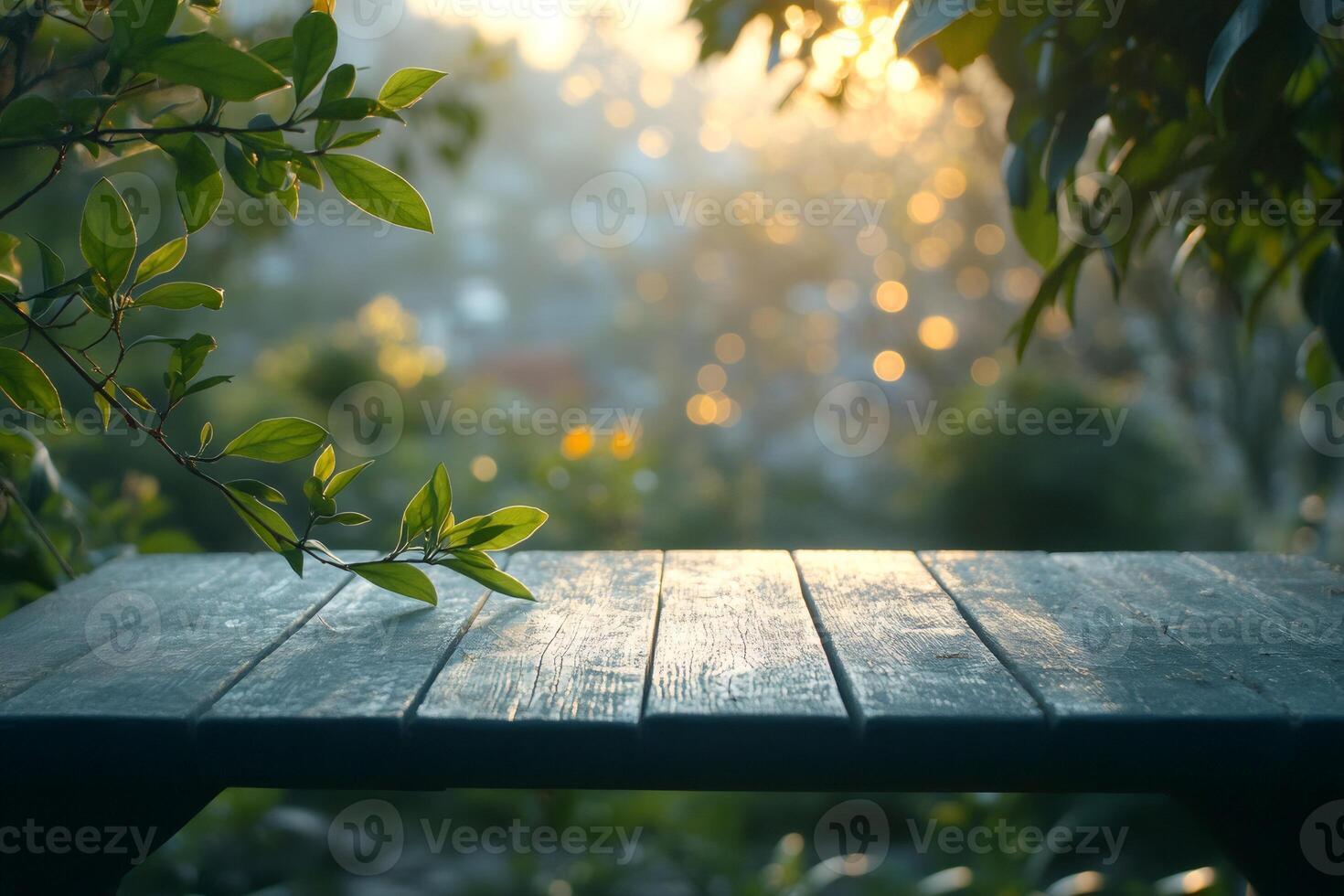 Empty wooden table in a garden during sunset with bokeh effect photo