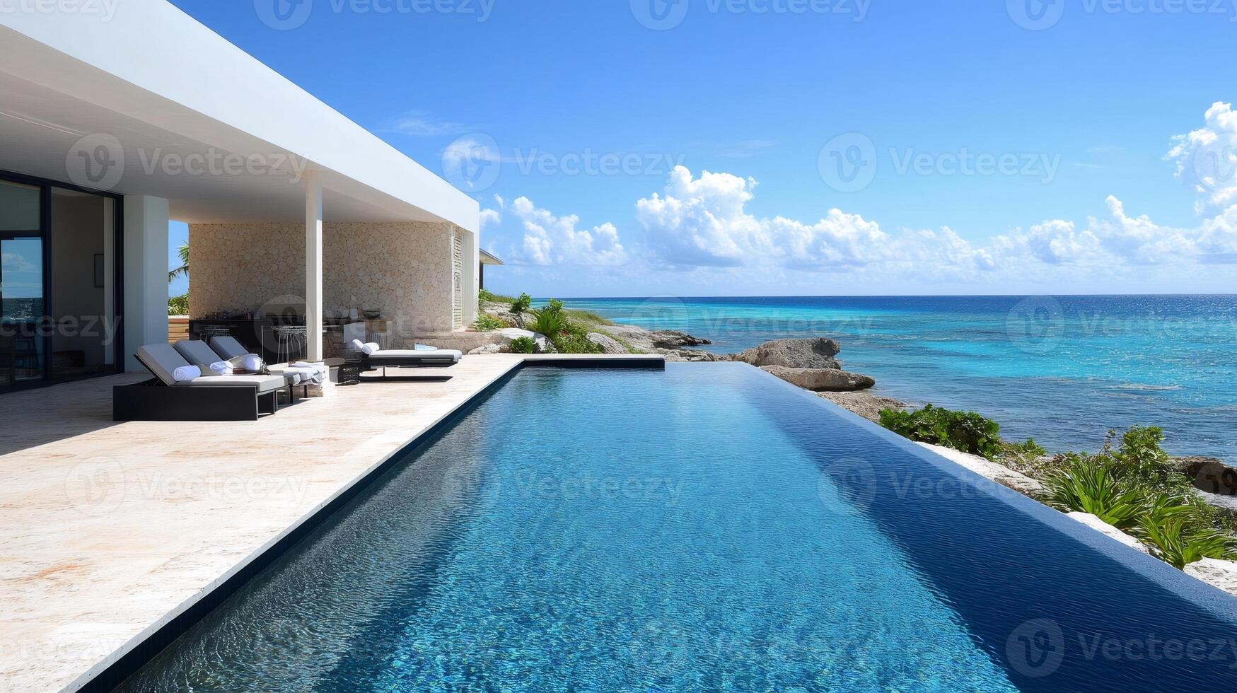 Infinity pool overlooking tranquil turquoise ocean at luxury resort photo