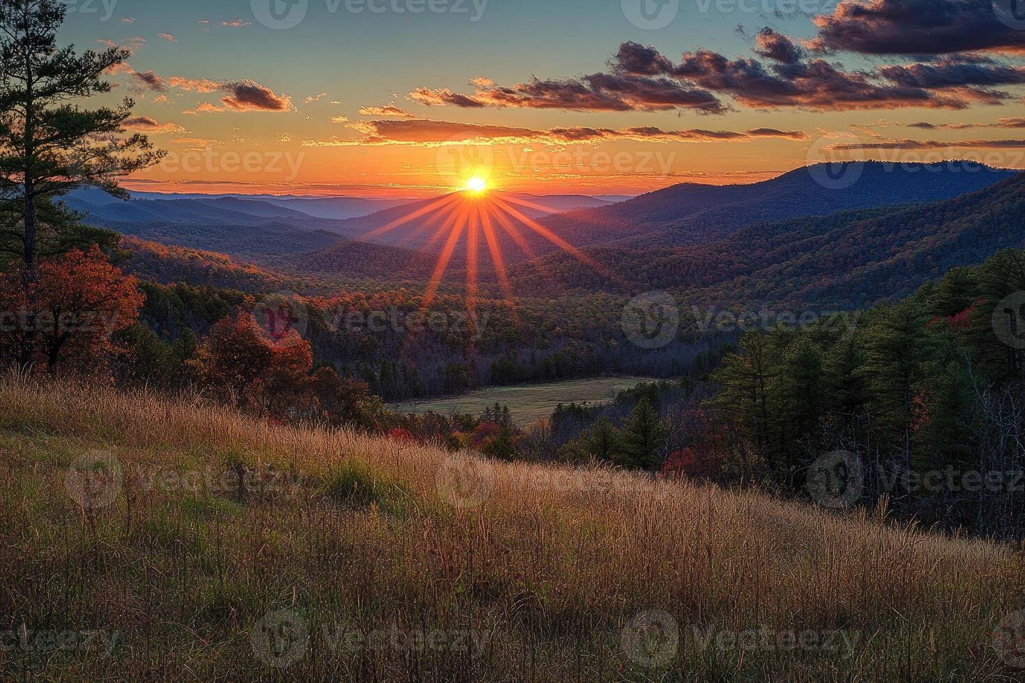 Beautiful sunset illuminating rolling hills and colorful autumn forest photo