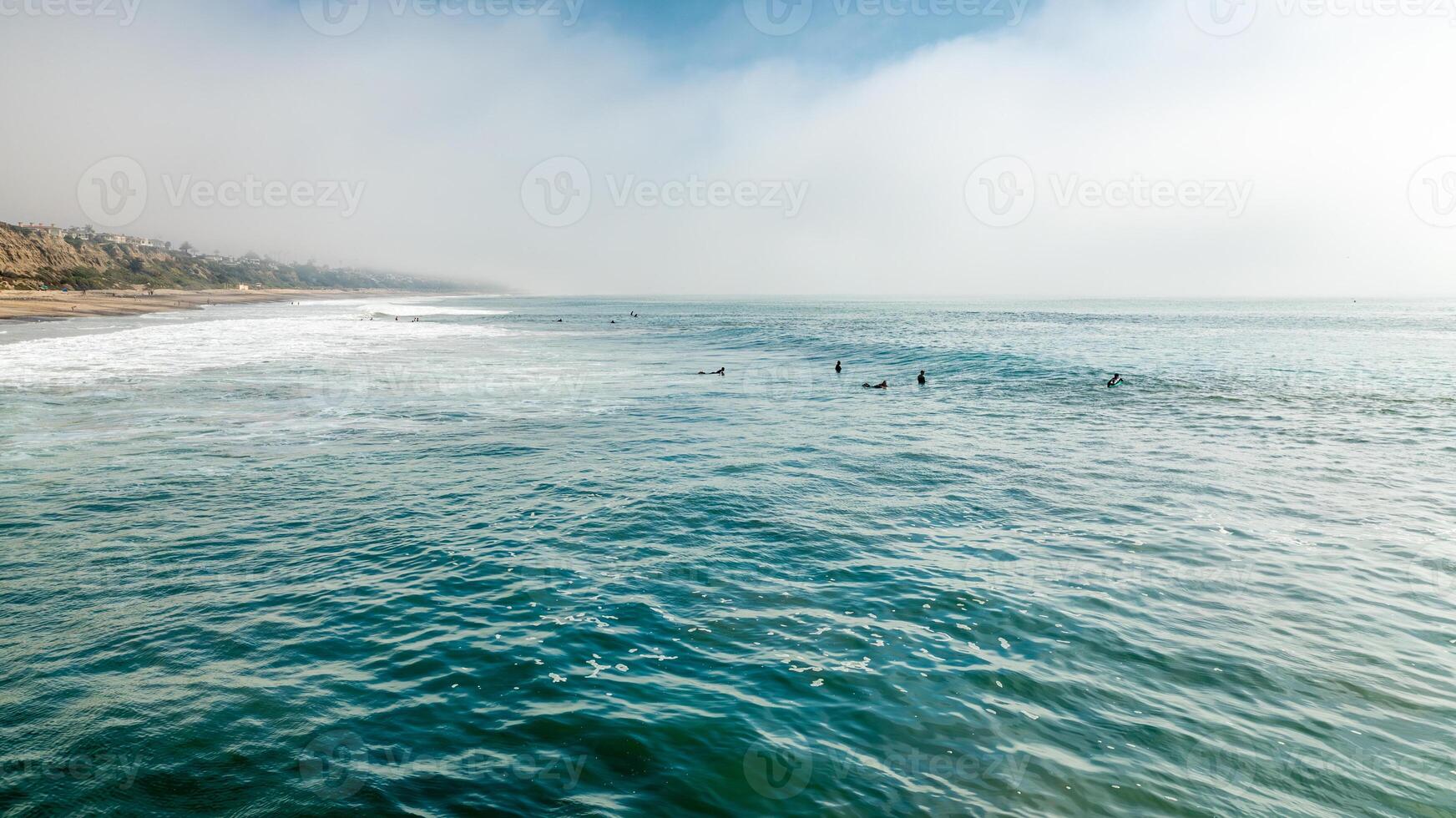 Majestic aerial view of surfers between waves at Trestles Beach in San Clemente photo