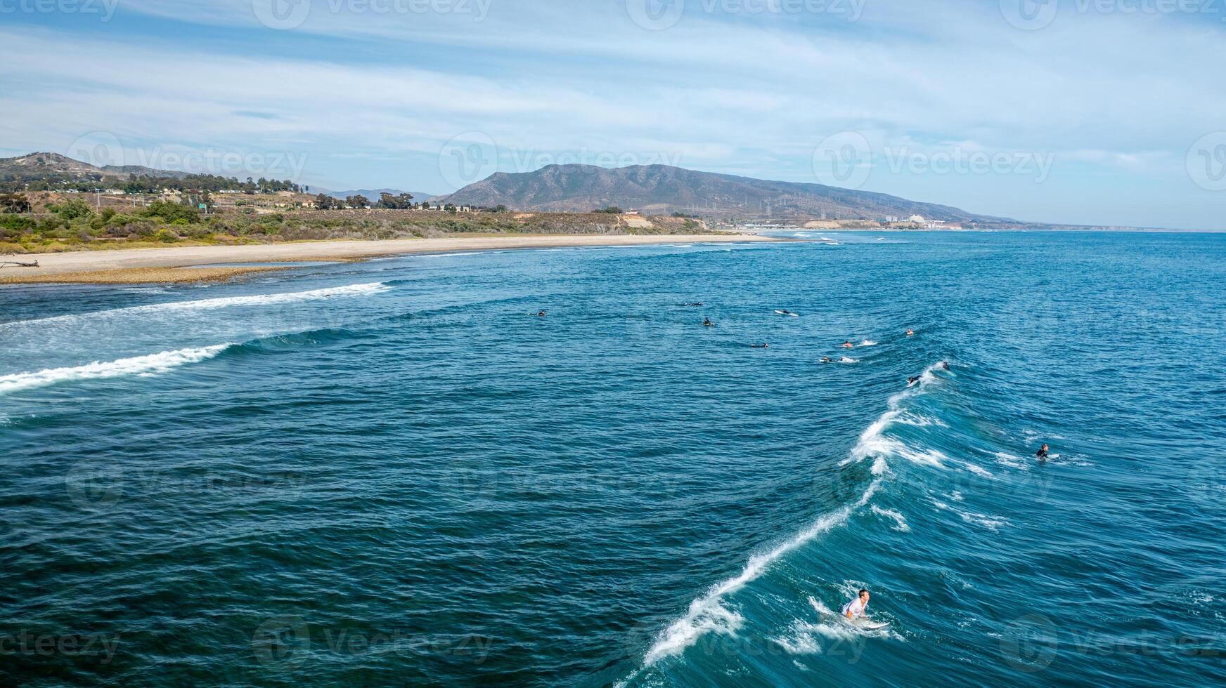 Captivating aerial view of the San Clemente coastline showcasing surfers riding waves at Trestles Beach photo