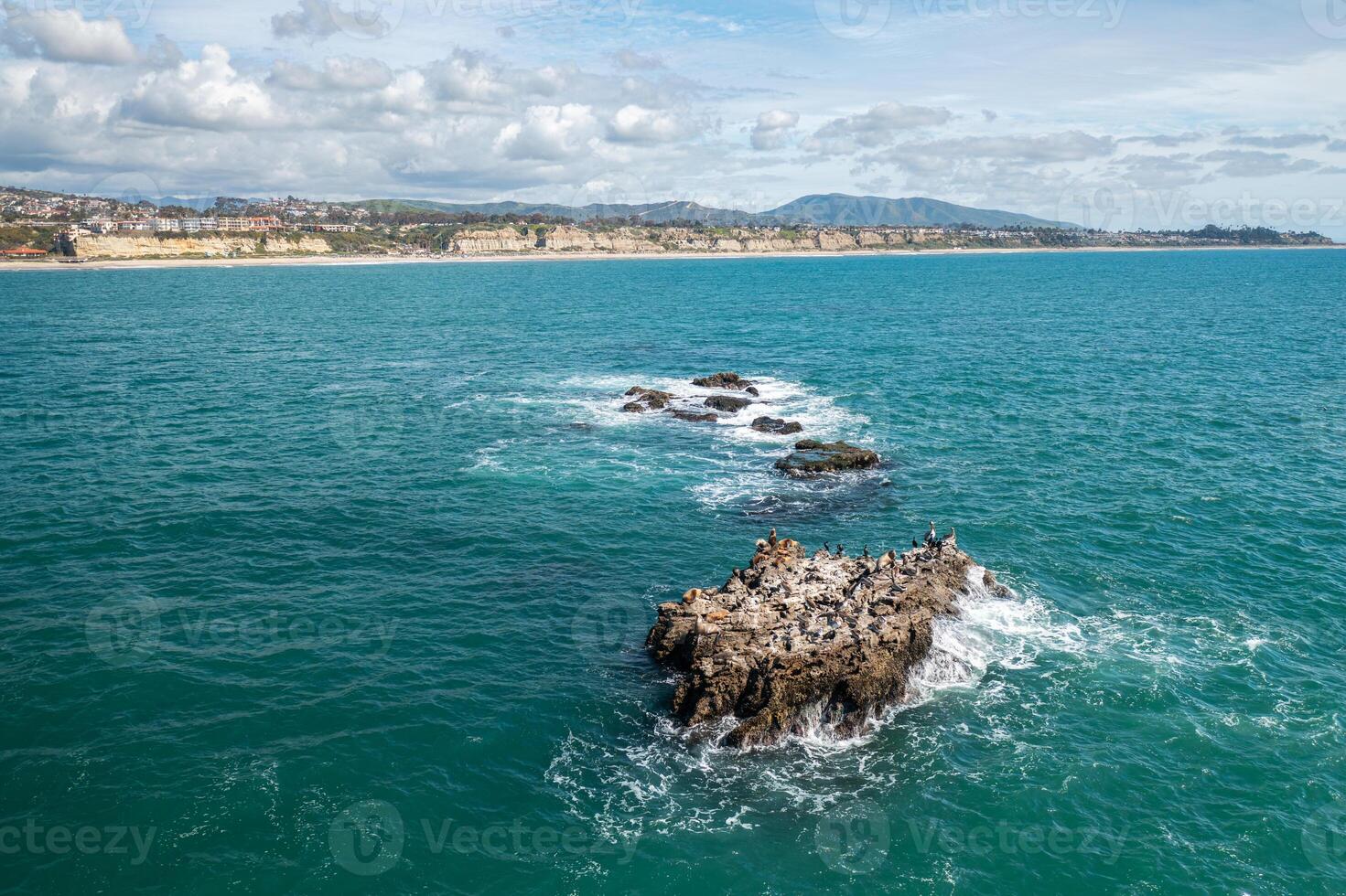Aerial view of San Clemente coastline showcasing Seal Rock rock formation and vibrant ocean waves photo