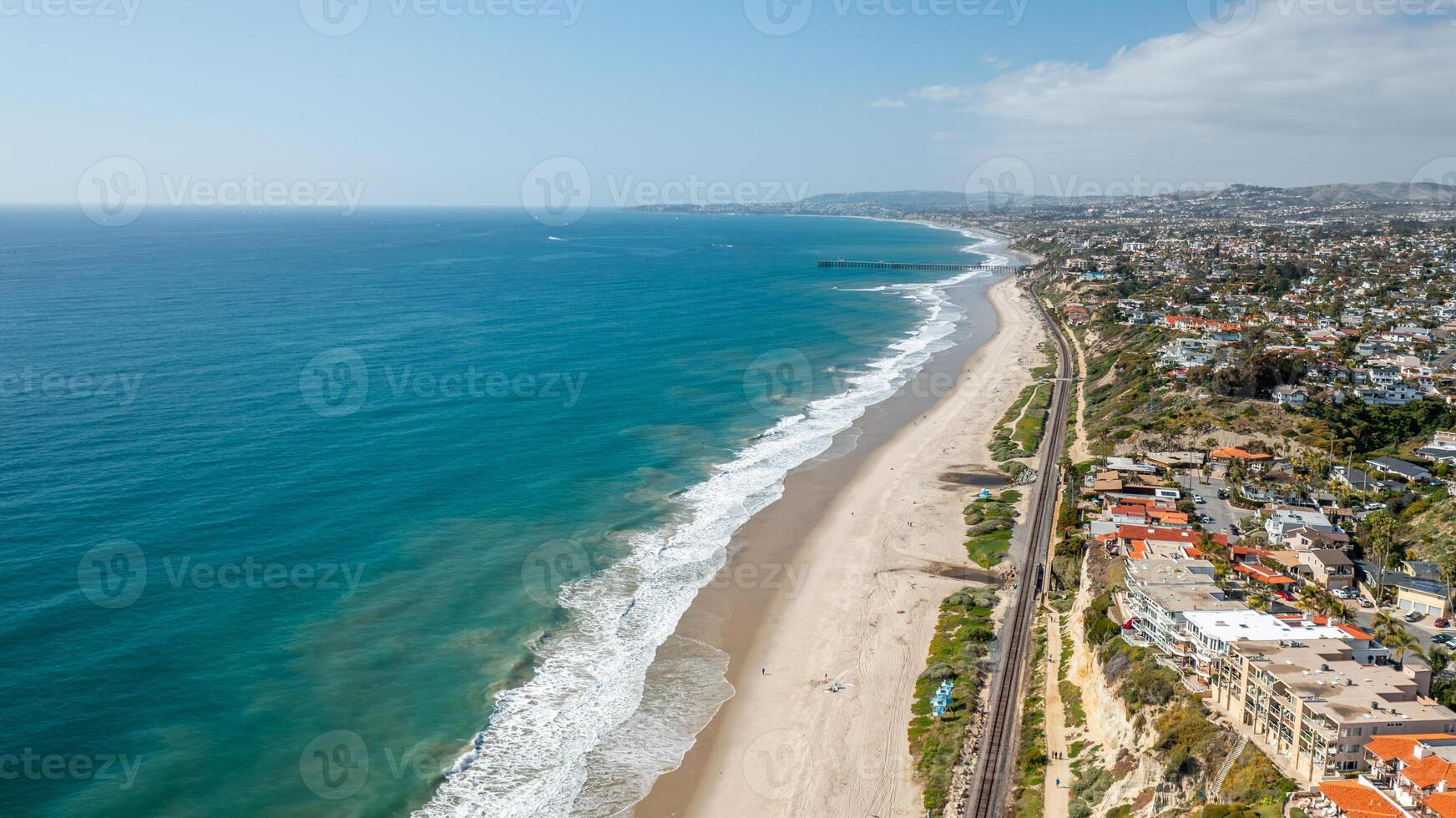Aerial view of San Clemente coastline showcasing sandy beaches and the Pacific Ocean with pier photo