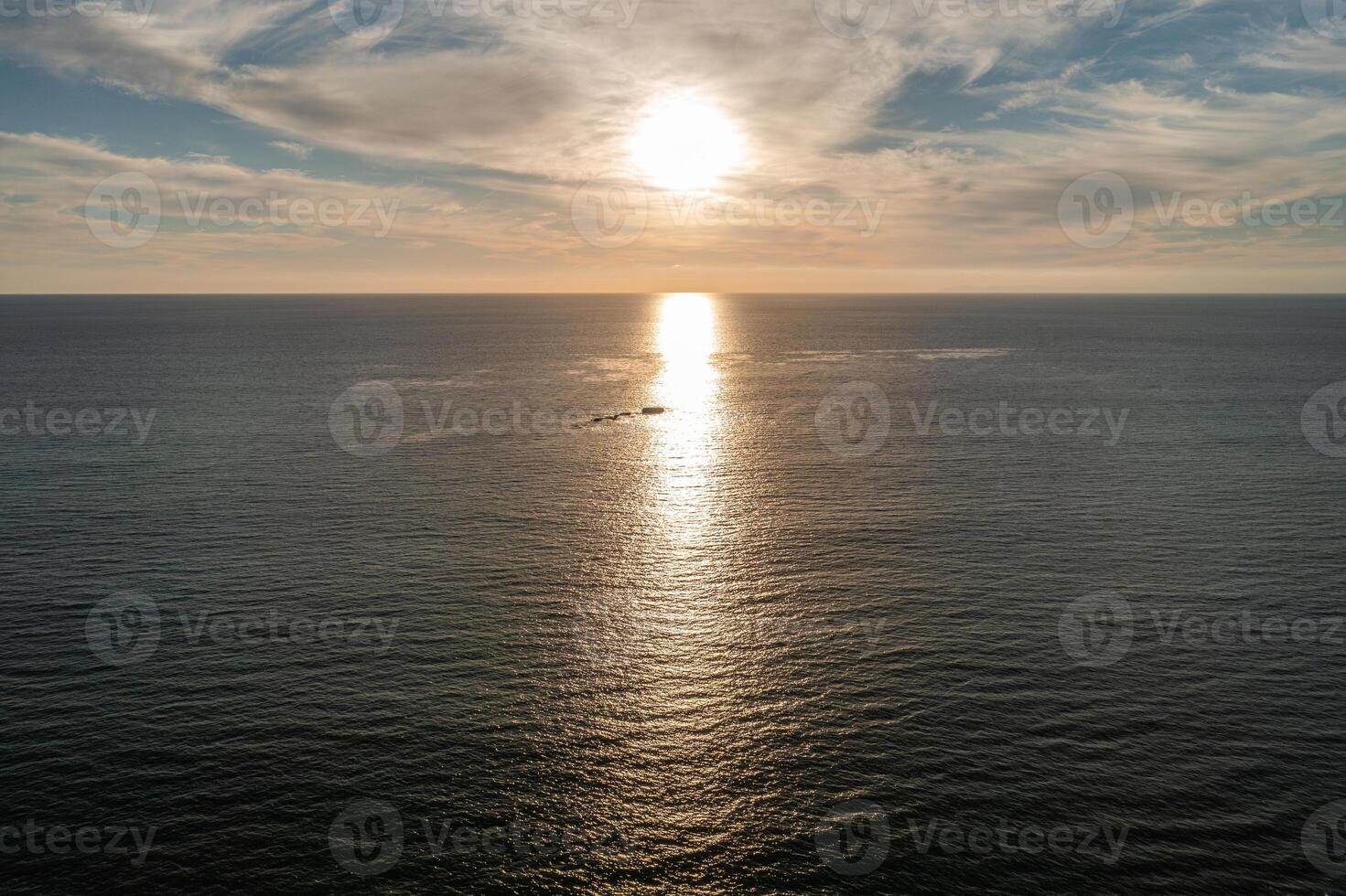 Aerial view of the sunset over the ocean near San Clemente California and Seal Rock in the distance photo