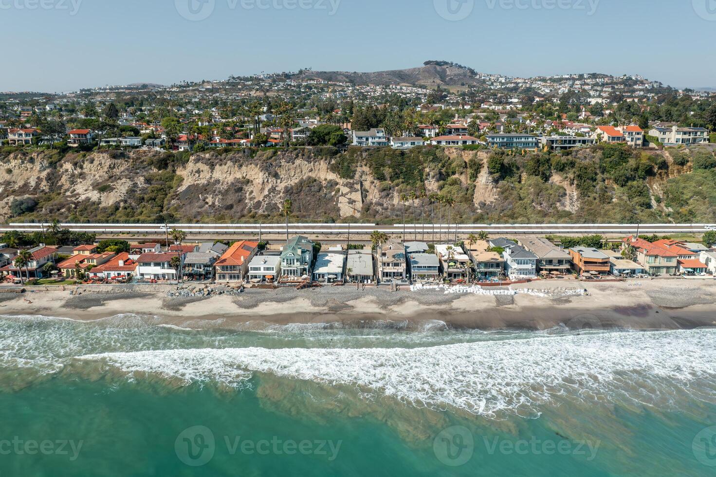 Mesmerizing aerial view of the Aerial of the tropical San Clemente coastline showcasing vibrant beach life and tranquil ocean waves photo