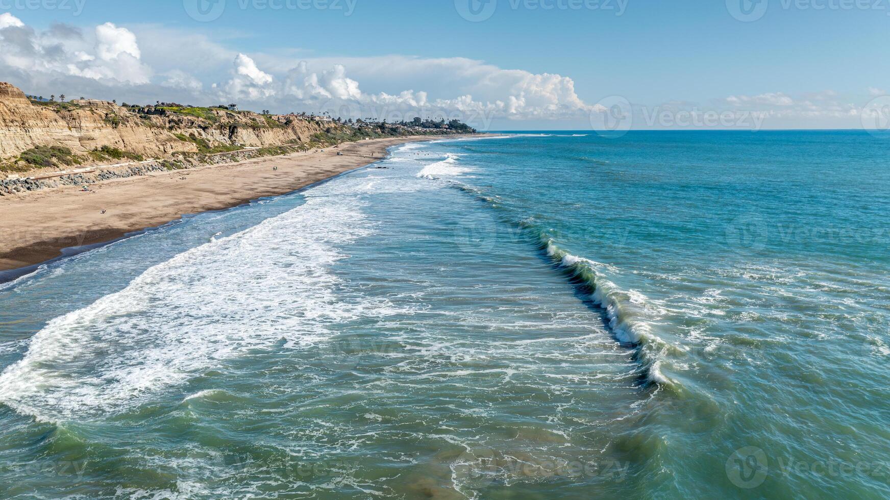Aerial view of the San Clemente California coastline featuring waves and sandy beaches under a clear sky photo