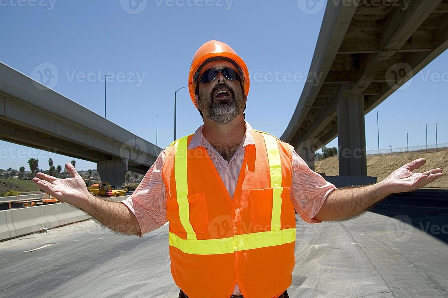 A man in an orange safety vest and hard hat photo