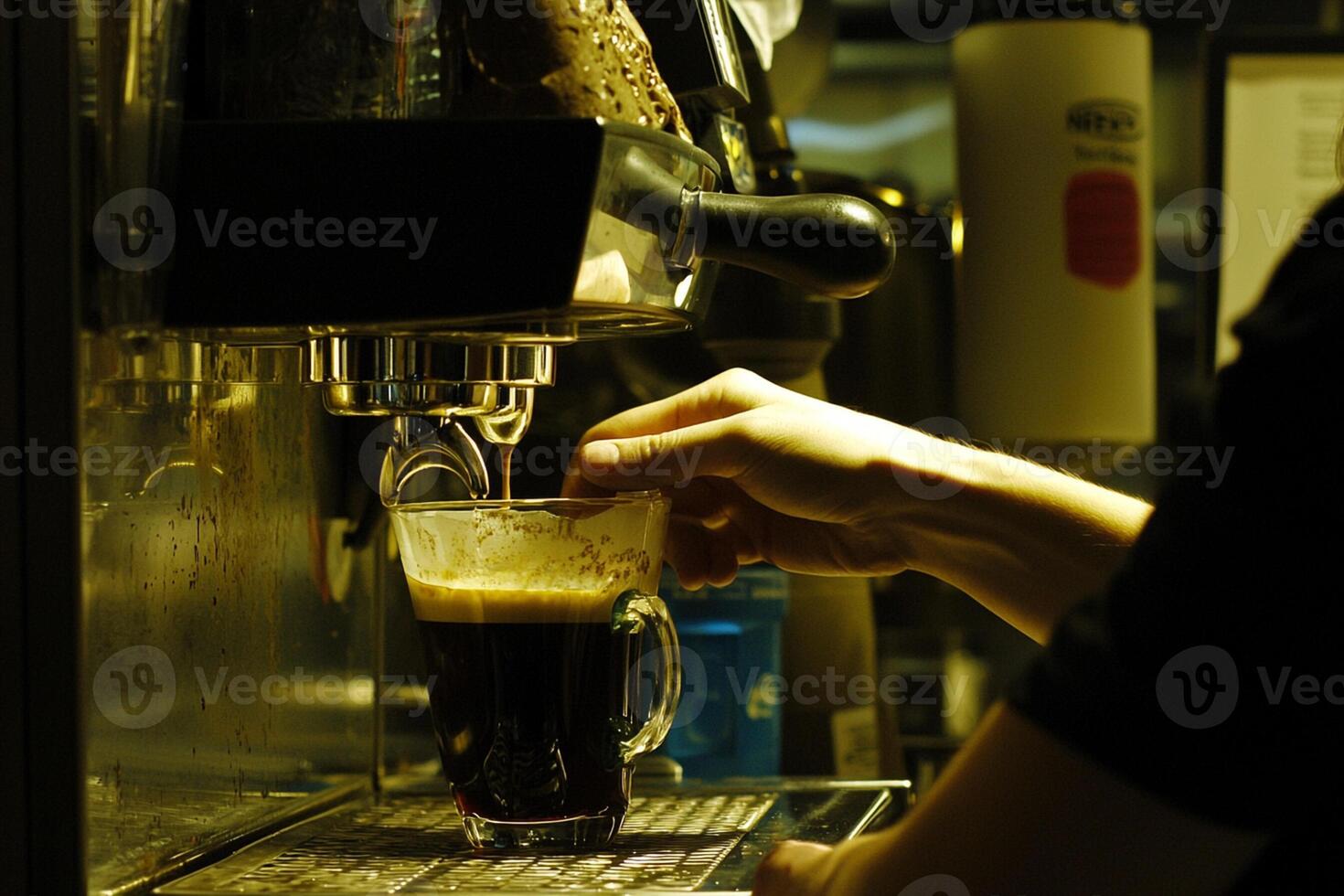 A person is pouring a drink into a cup photo