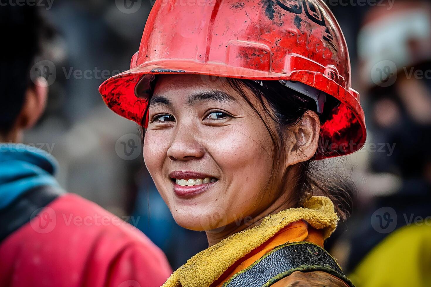A woman wearing a hard hat and smiling photo