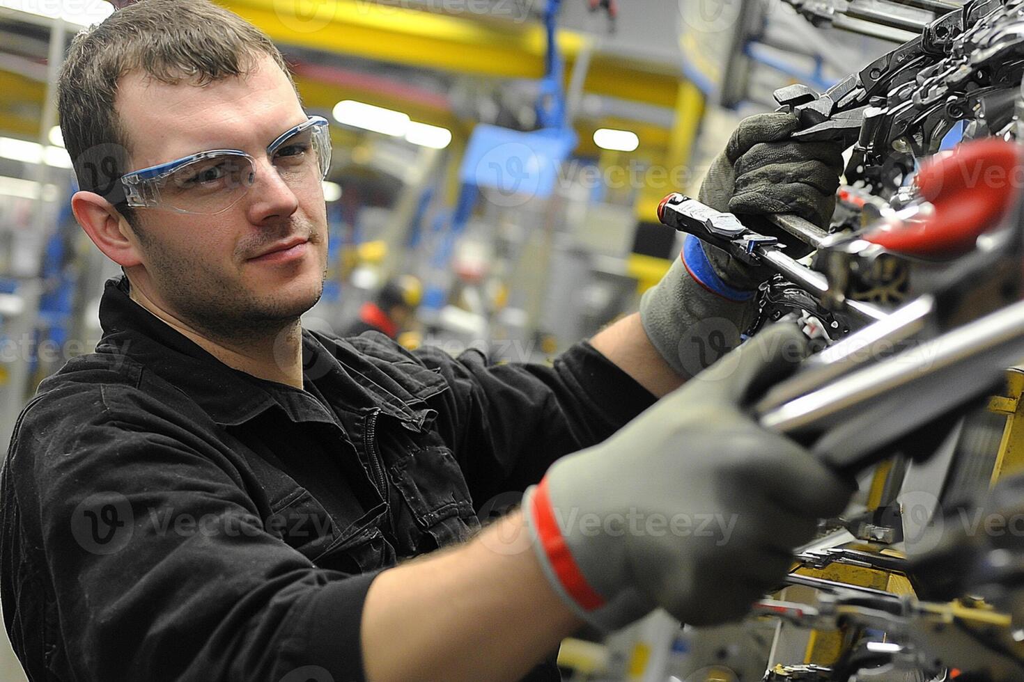 A man working on a machine in a factory photo