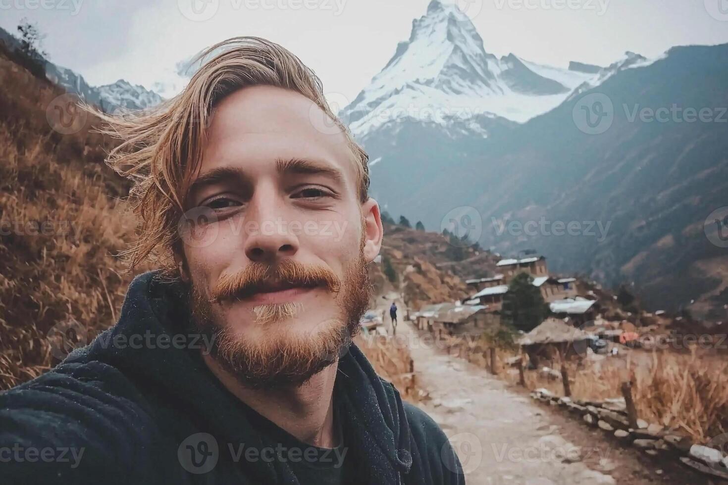 A man with a beard and a beard taking a selfie photo