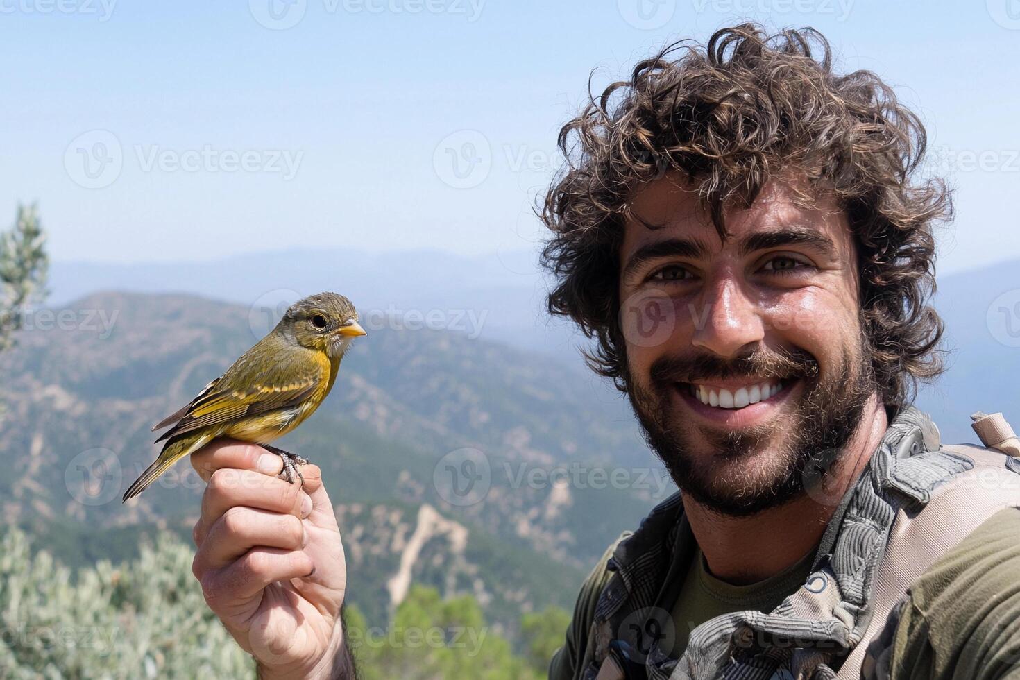 A man with a beard and a yellow bird on his hand photo