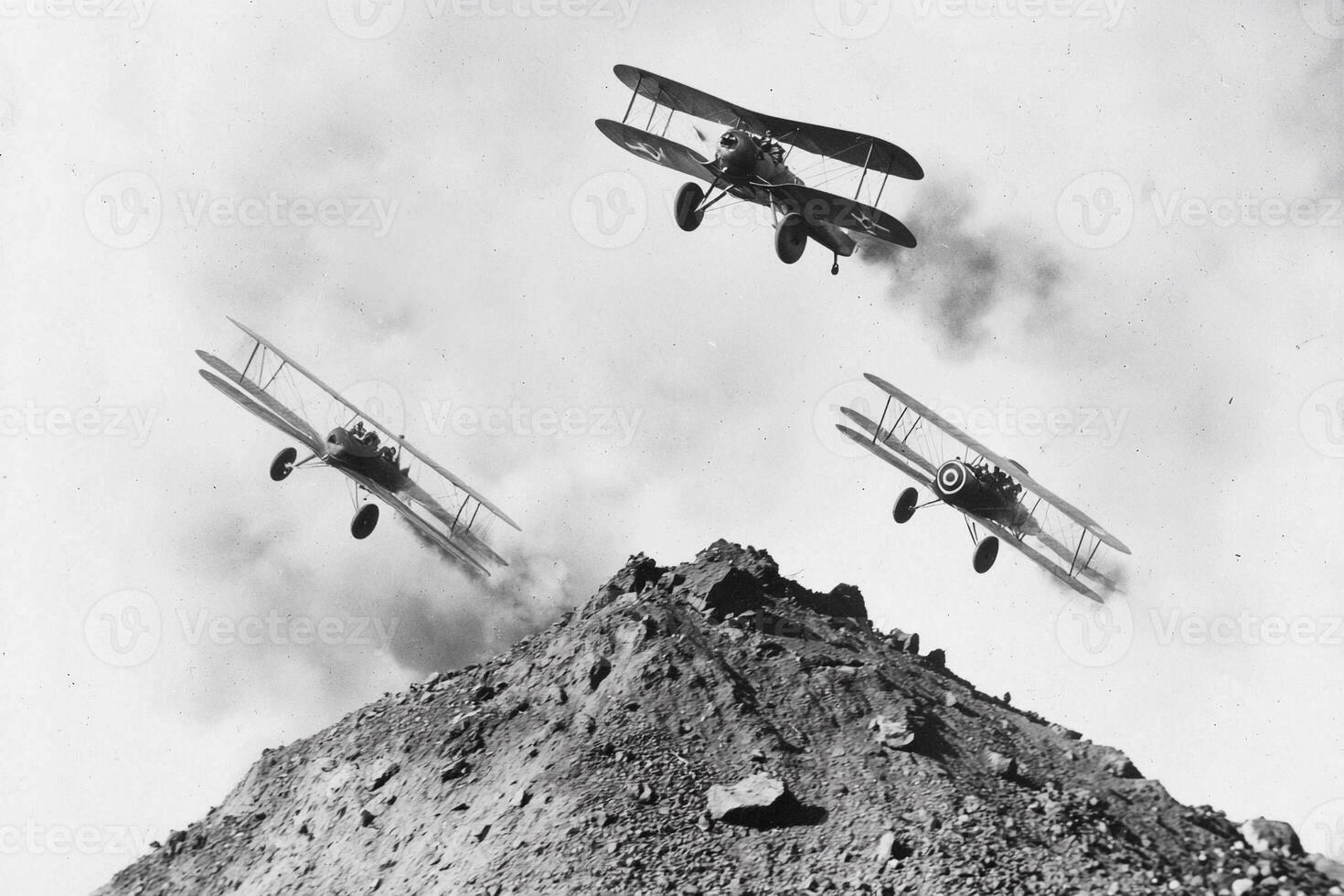 Three airplanes flying over a mountain with smoke coming out of them photo
