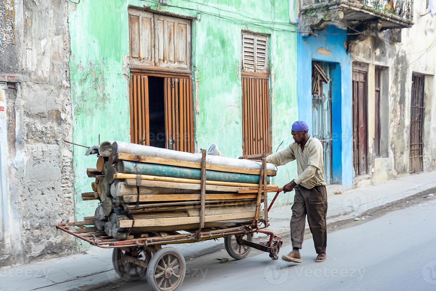 A man pushing a cart with wooden boards on it photo