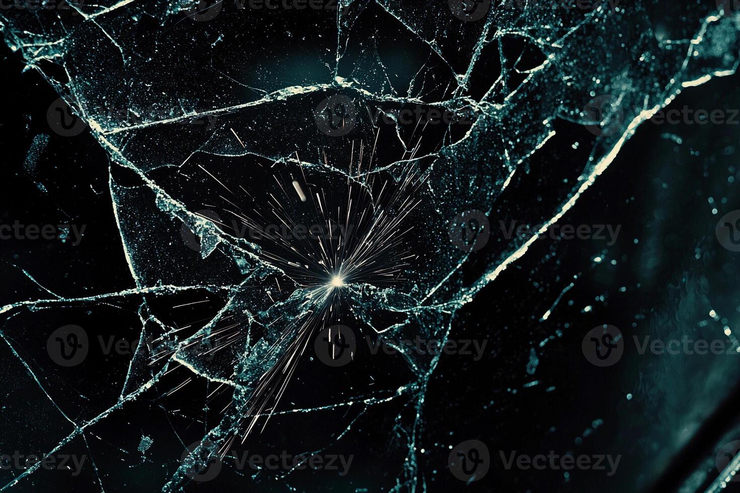 A broken glass window with a hole in it photo