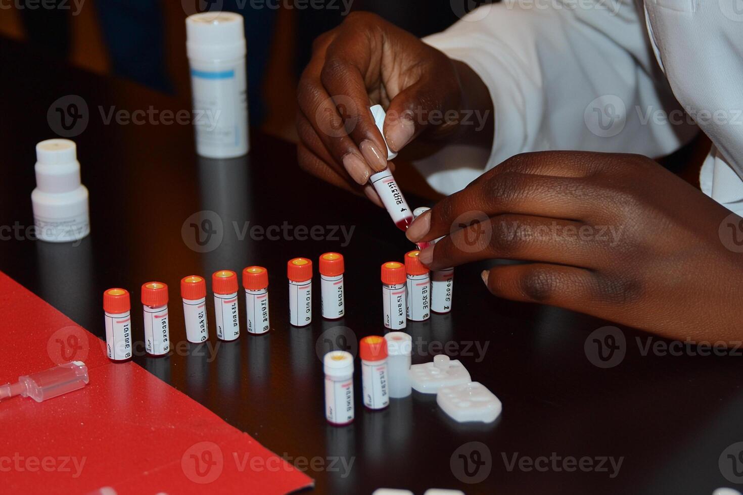 A person is putting some medicine into a tube photo