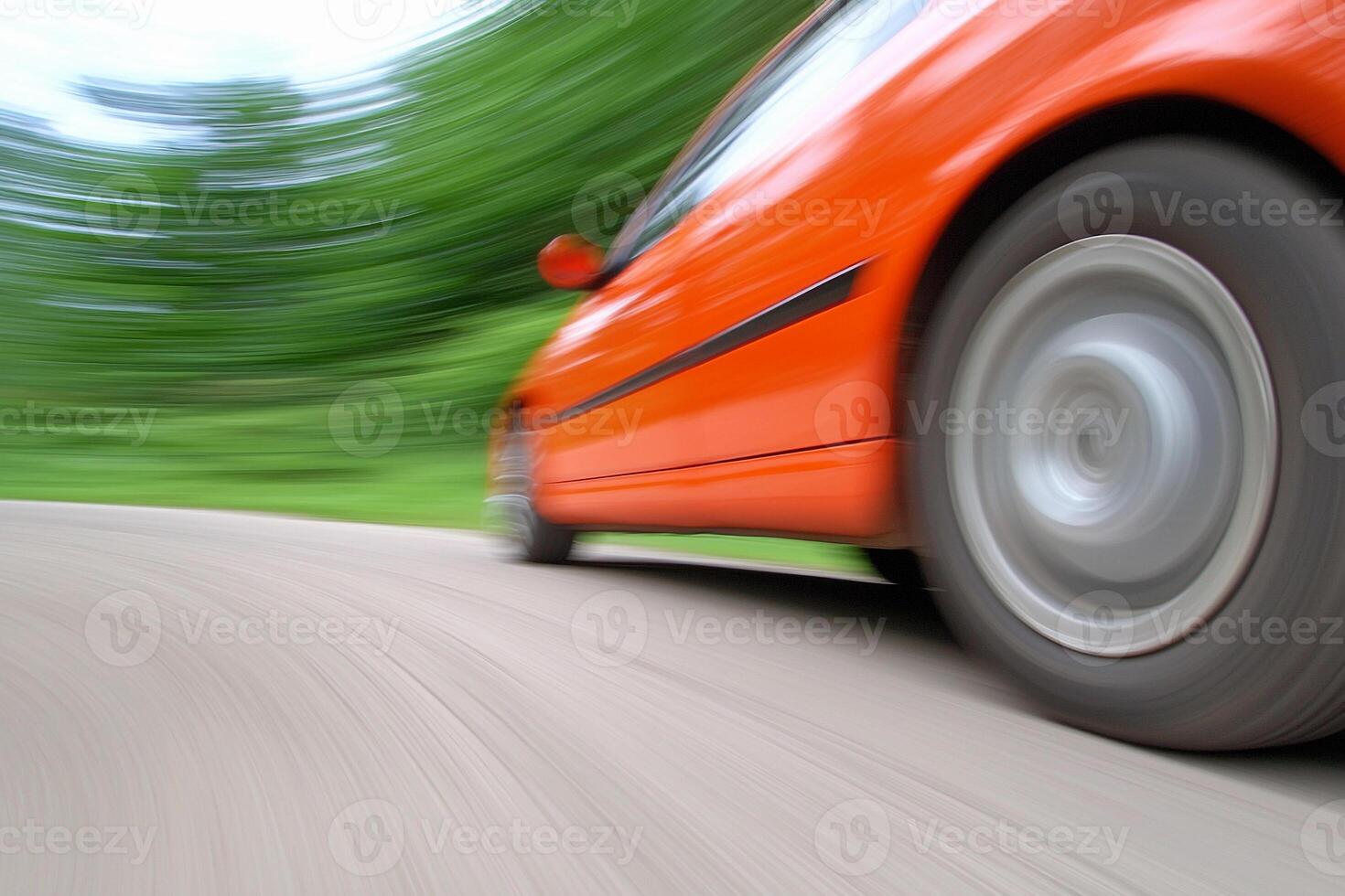 A blurry image of a car speeding down the road photo