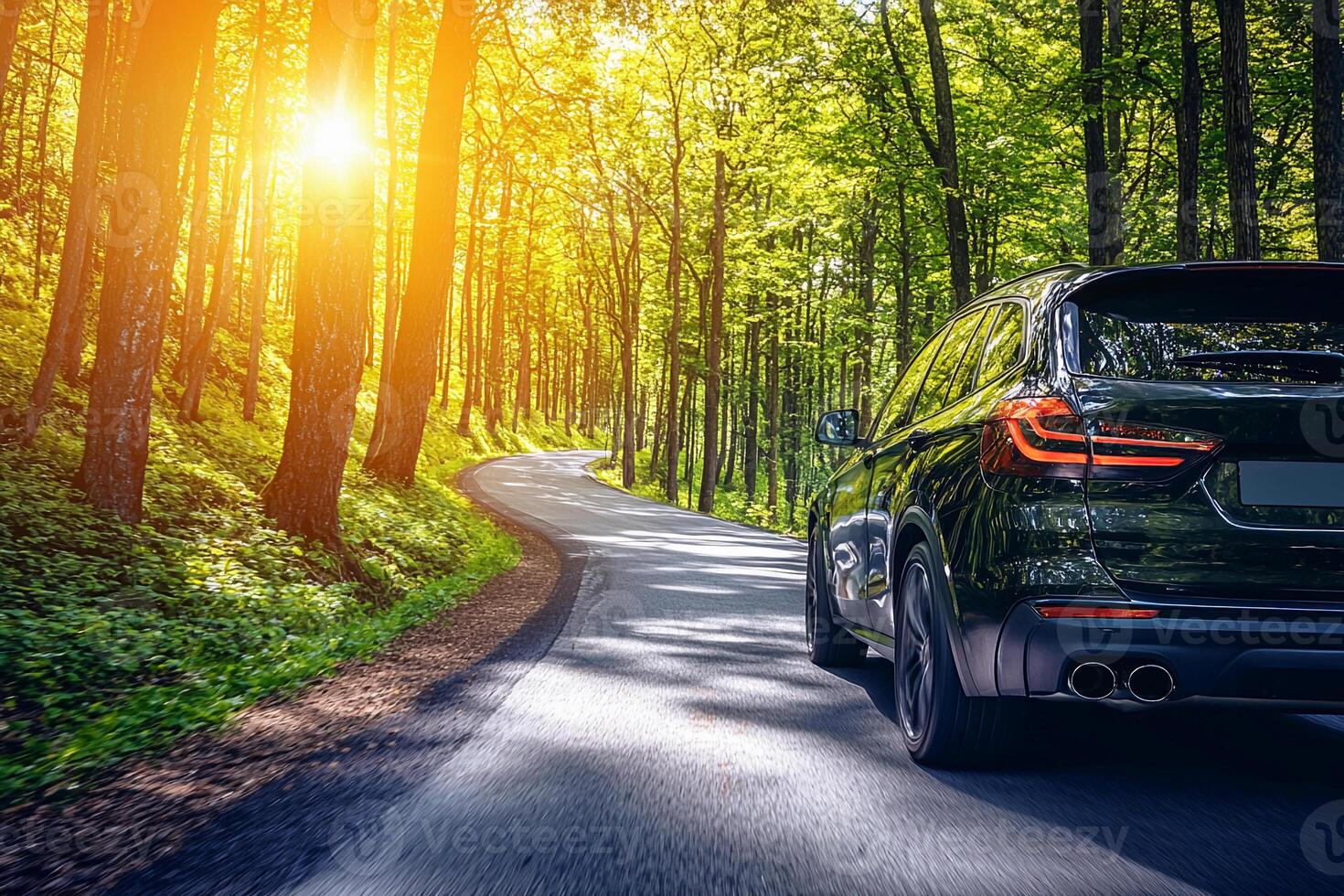 Black suv driving on a road in the forest photo