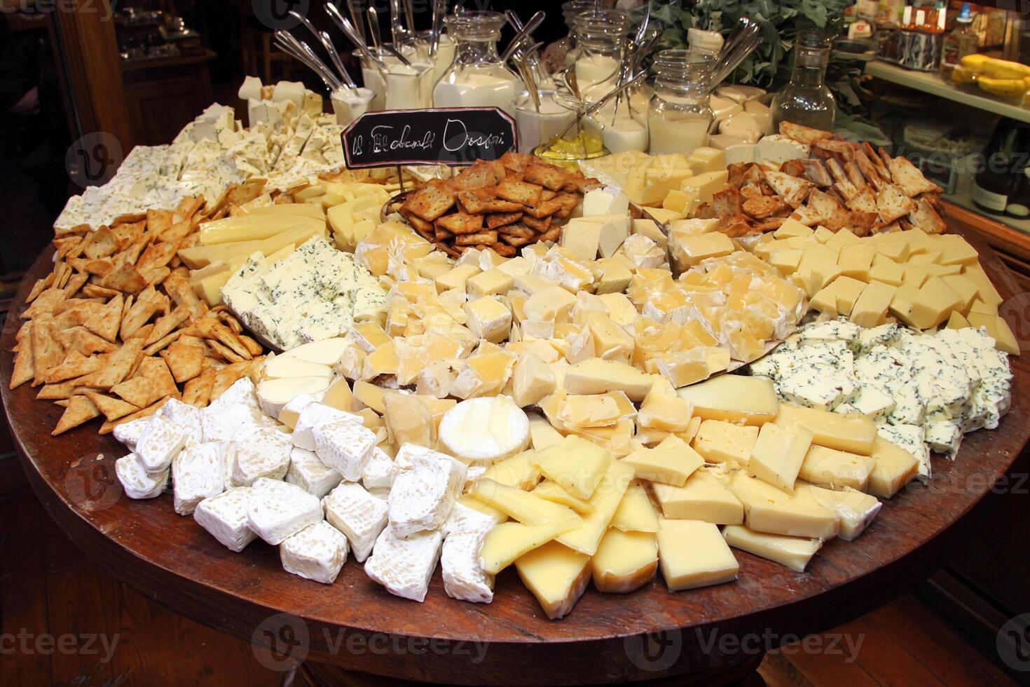 A table with a lot of cheese and crackers photo