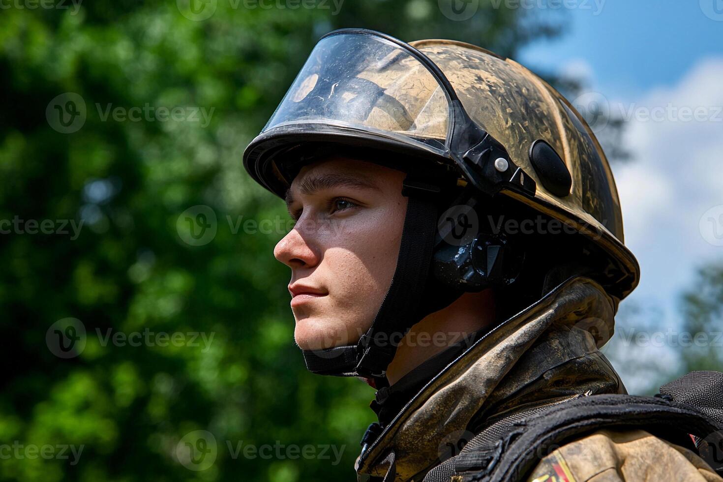 A man wearing a helmet and a fireman's uniform photo