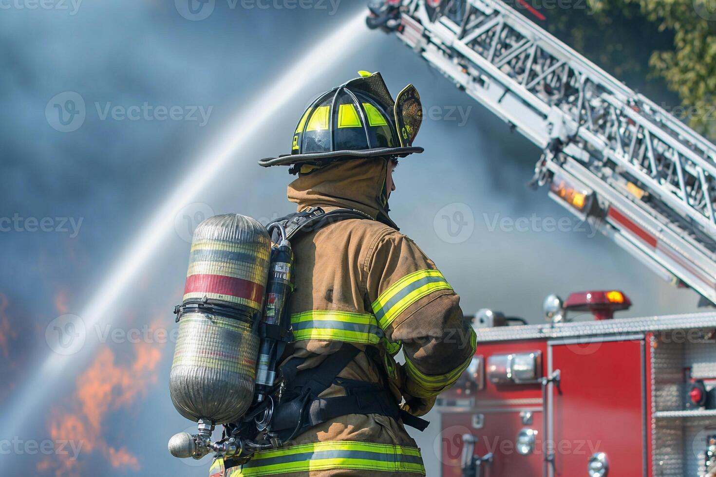 A firefighter is standing in front of a fire truck photo