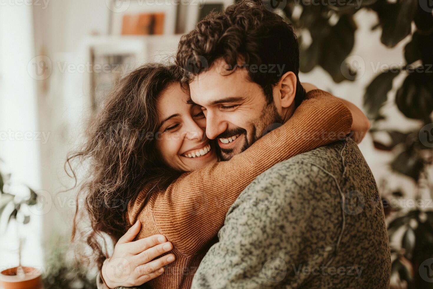 A man and woman embrace in a living room photo