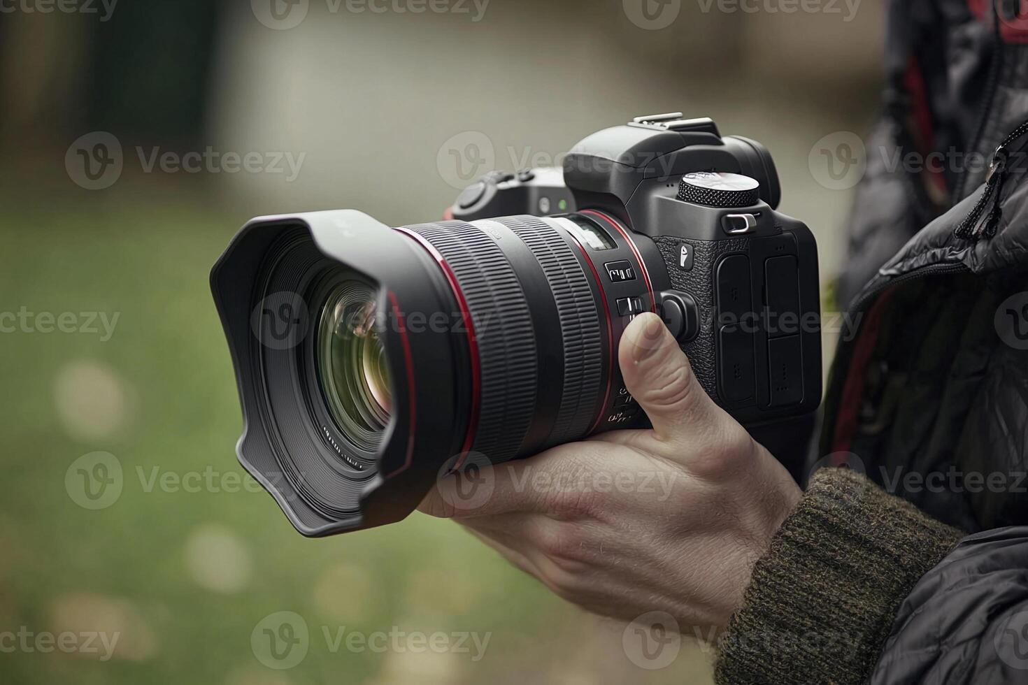 A person holding a canon camera with a lens photo