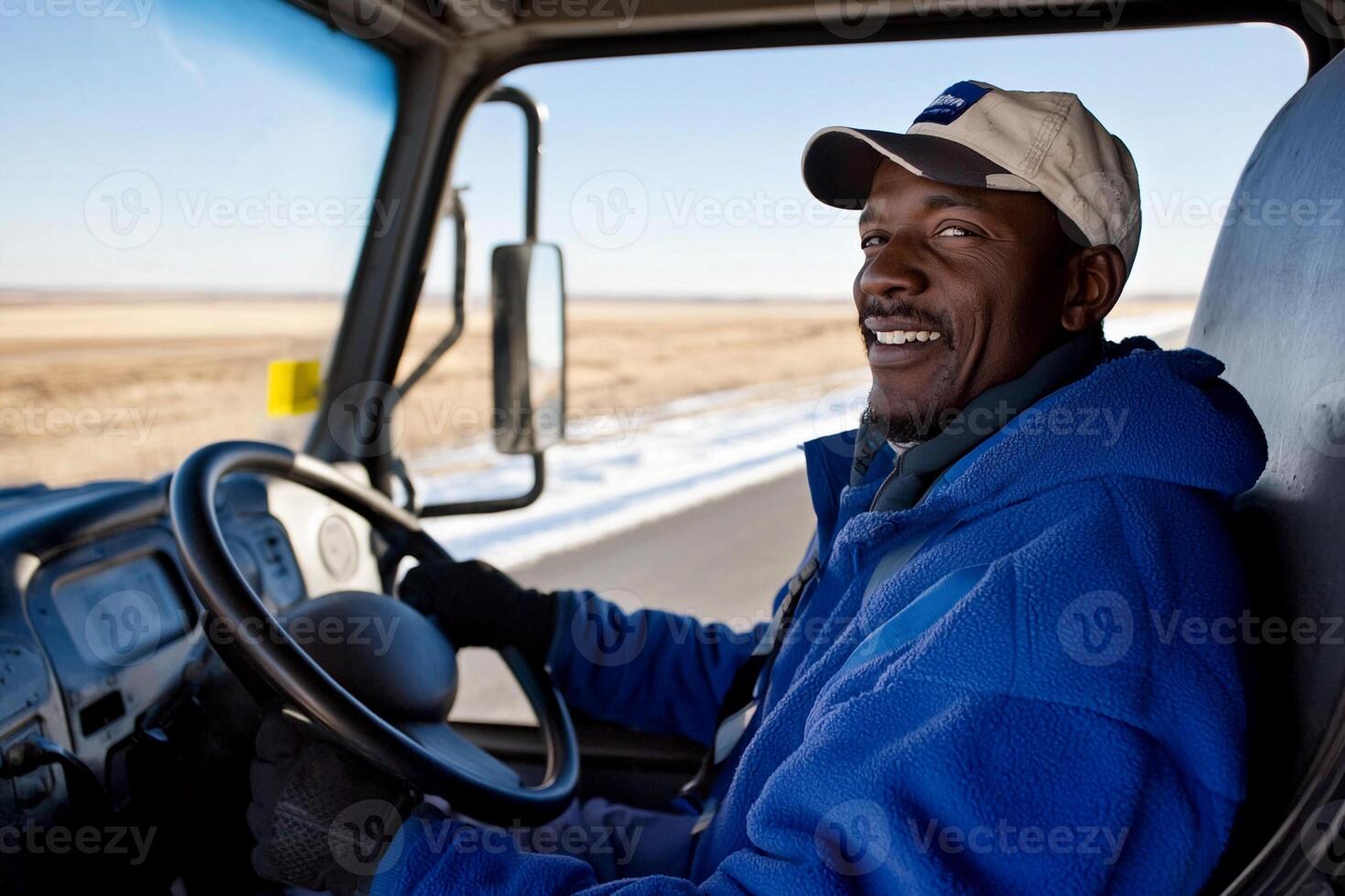 A man smiles while driving a truck photo