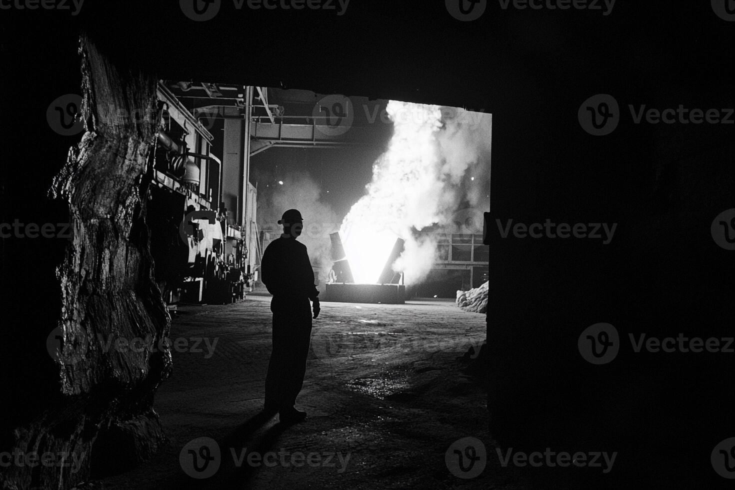 A man standing in front of a large fire photo