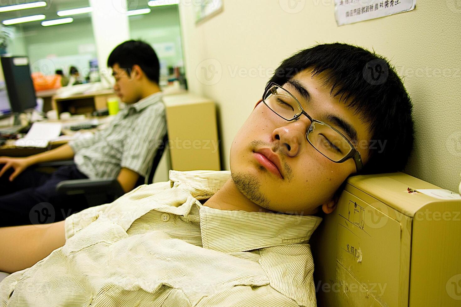 A man sleeping on a desk photo