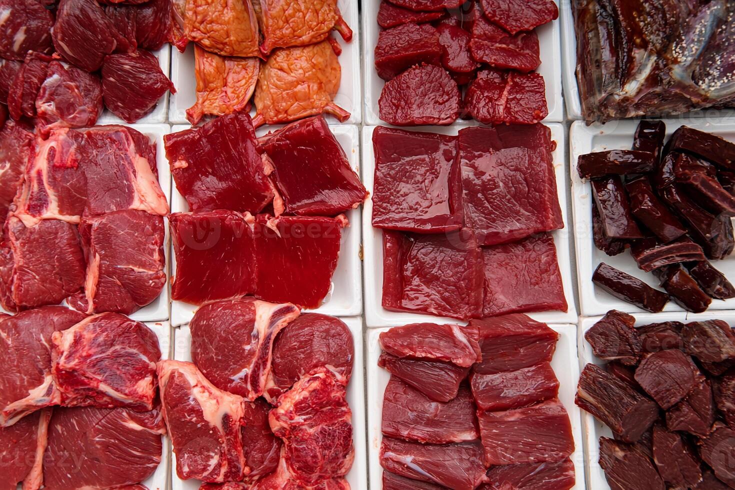 Meat is displayed in a display case photo