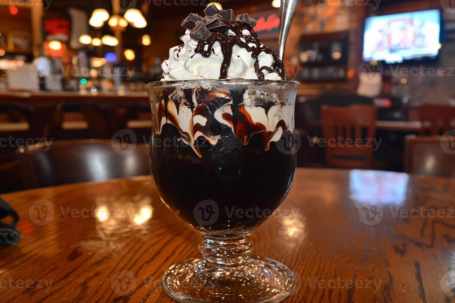 A dessert with whipped cream and chocolate on top photo