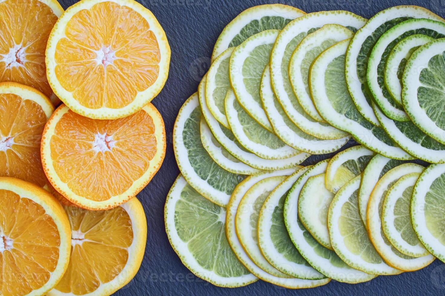 Sliced oranges and lemons on a blue surface photo