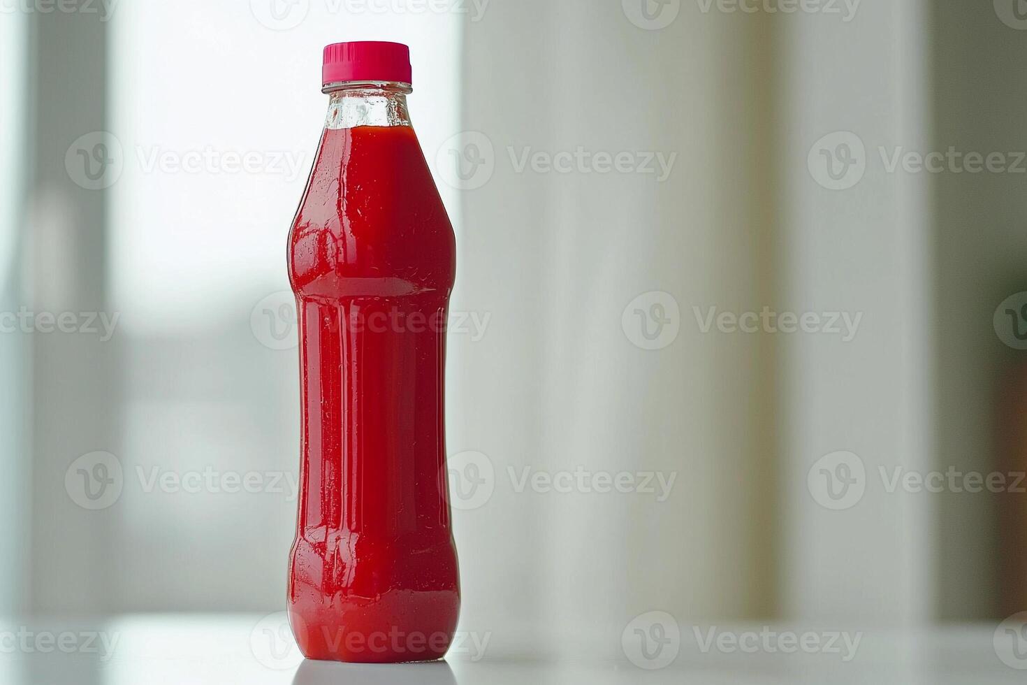 A bottle of red sauce sitting on a table photo