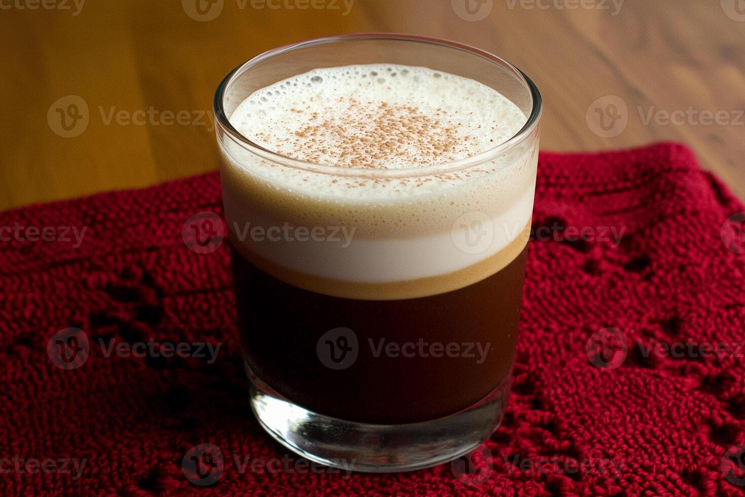 A glass of coffee and a red cloth on a table photo