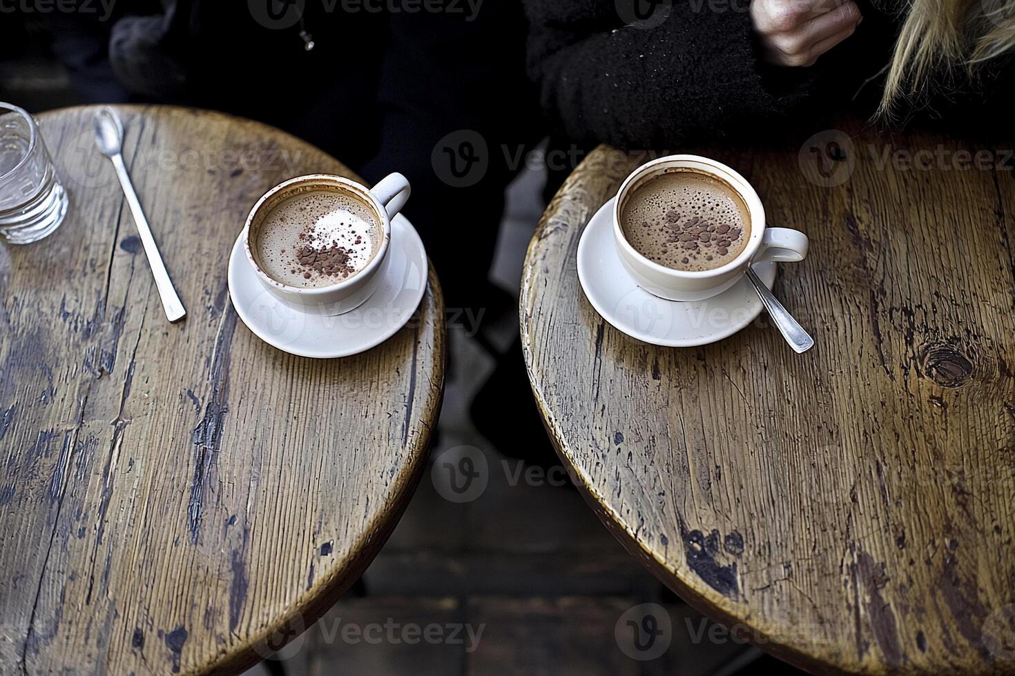 Two cups of coffee on wooden tables photo