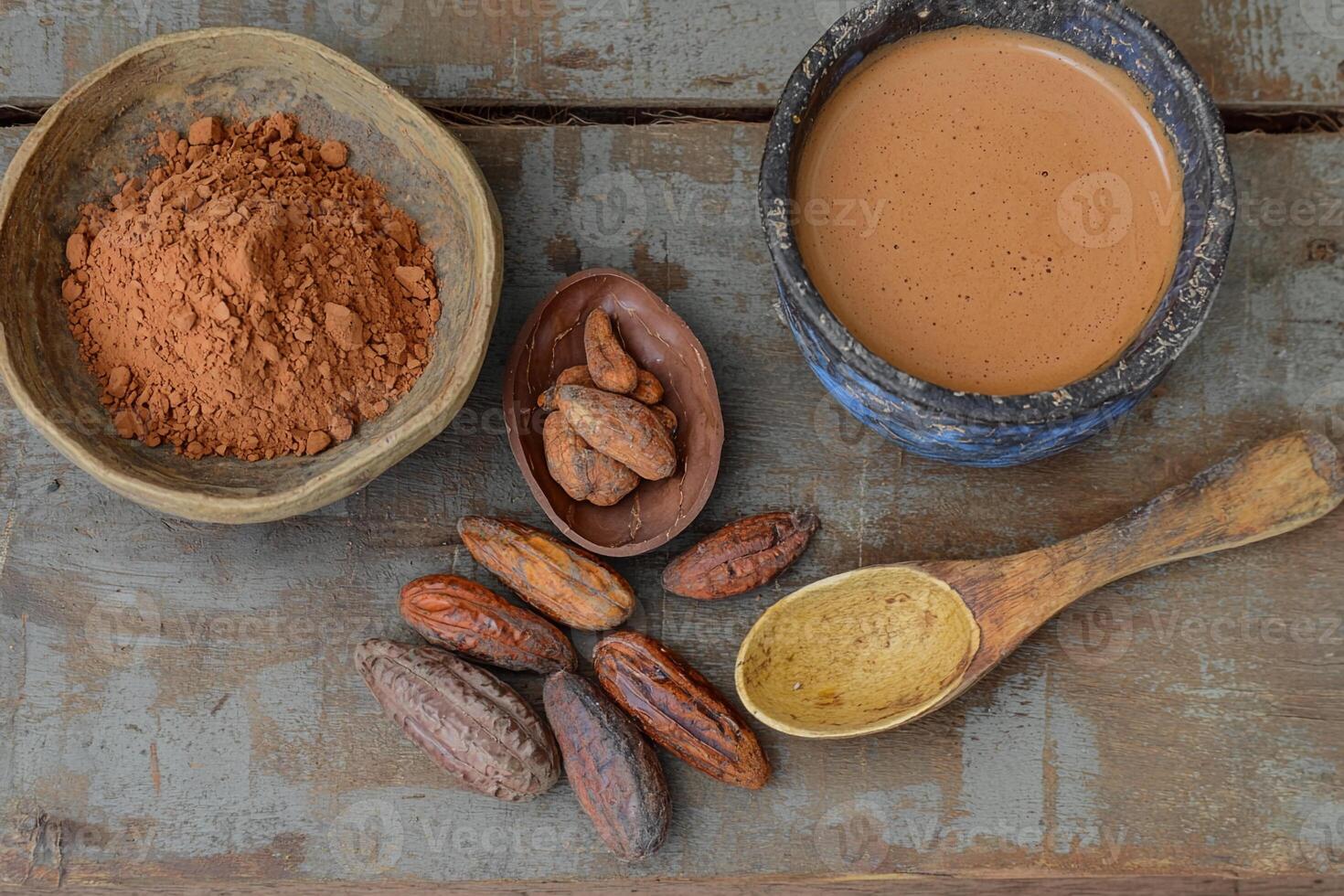 Cocoa powder, cocoa beans, and cocoa beans on a wooden table photo