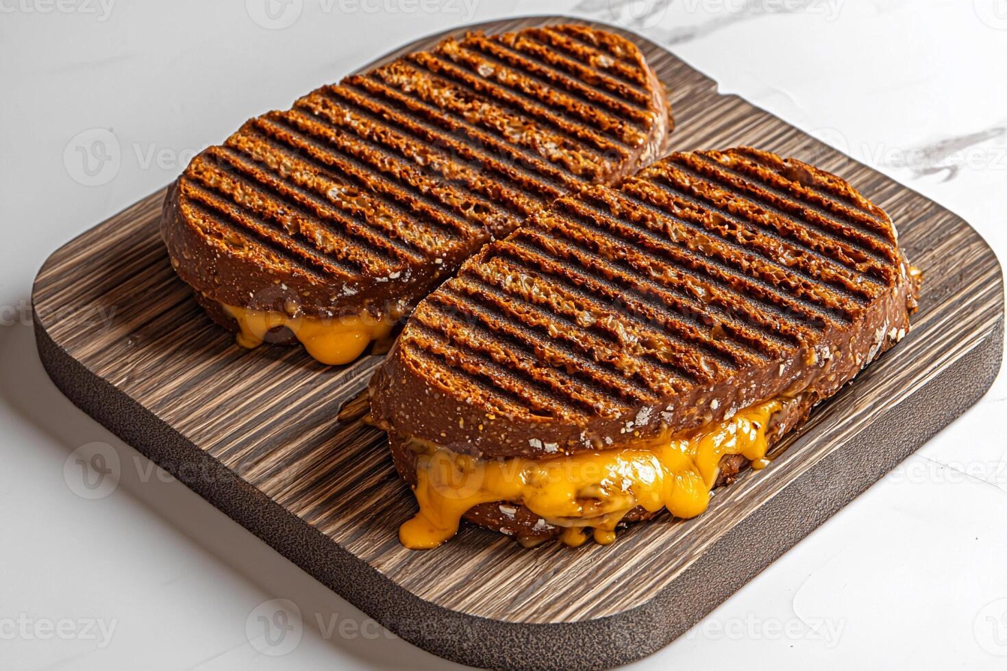 Grilled cheese sandwich on a wooden cutting board photo